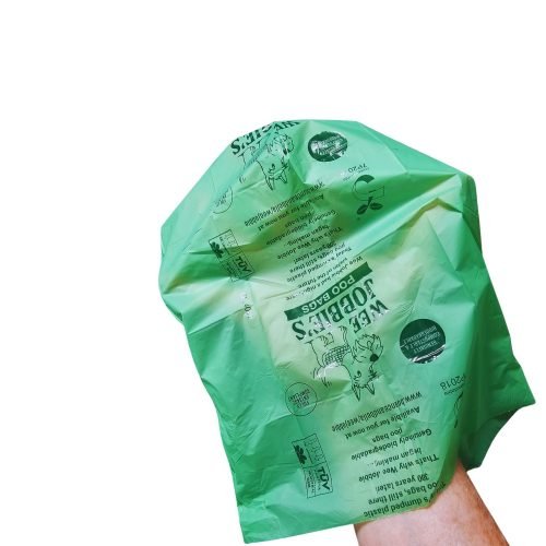hand in a biodegradable poo bag